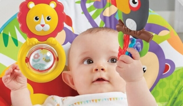 Baby playing with toys in Fisher-Price bouncer