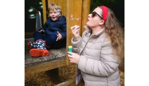 mother and son in the playground in UNIQLO jackets