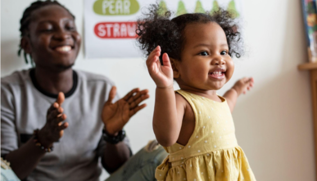 Happy child and dad in background