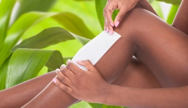 Woman waxing her legs