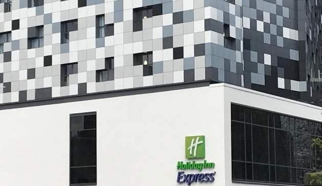 Close up picture of Holiday Inn logo on the side of the hotel.