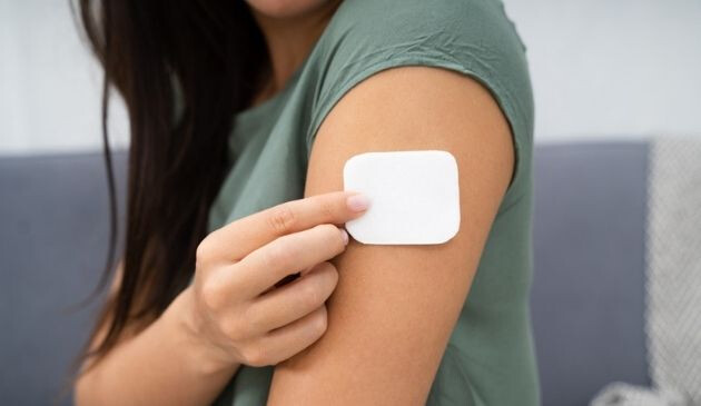 woman applying HRT patch