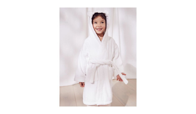 A young child with dark hair wearing a Hydrocotton Robe with Ears from The White Company