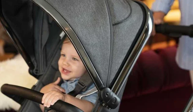 Laughing boy sitting in icandy peach buggy