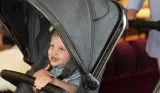 Laughing boy sitting in icandy peach buggy