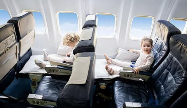Kids on a flight using the JetKids BedBox by Stokke ride on suitcase
