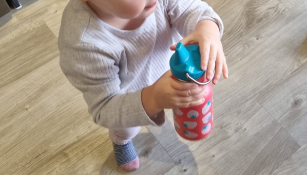 Child holding Klean Kanteen Kid Classic Sippy Cup