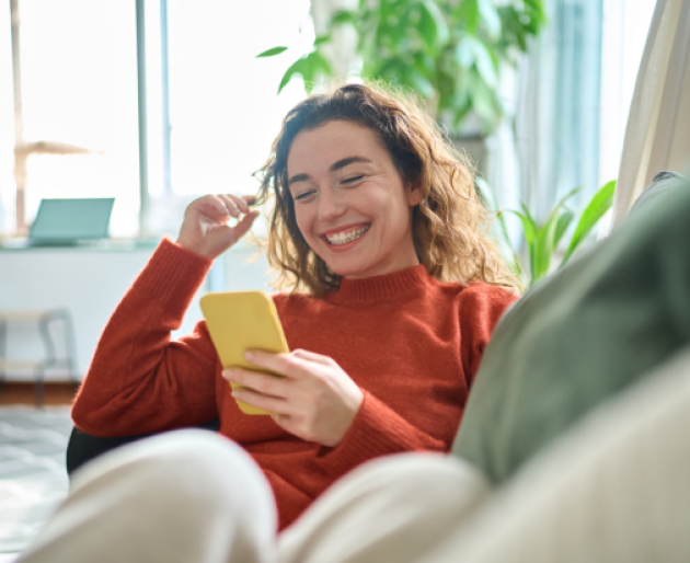 Woman smiling at phone