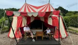A father and son outside a glamping tent at Leeds Castle