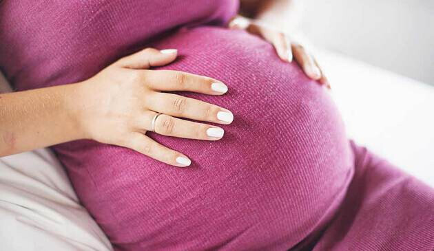 pregnant woman touching belly