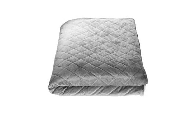 A grey blanket neatly folded on a white background