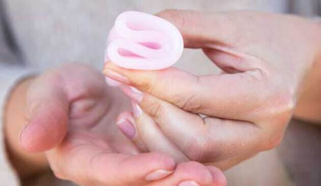 Woman holding folded menstrual cup