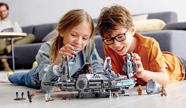 Children playing with Lego Star Wars Millenium Falcon