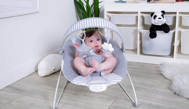 Baby laying in Red Kite Cozy Bounce Linen