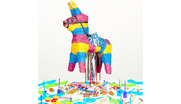 A striped donkey shaped pinata with plastic toys below it