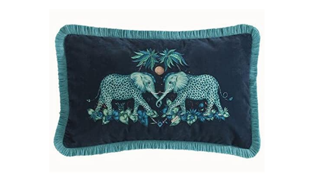 A blue tasselled cushion with an elephant print by Emma Shipley