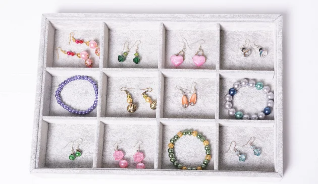 a jewellery tray with lots of colourful earrings and bracelets