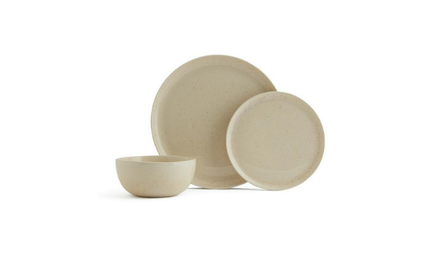a set of beige plates and bowls