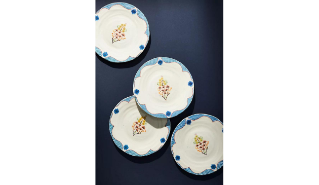 four patterned plates on a dark background