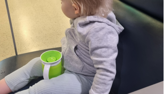 Munchkin Miracle 360 sippy cup and toddler at airport