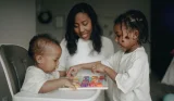 Two children and mother playing alphabet game