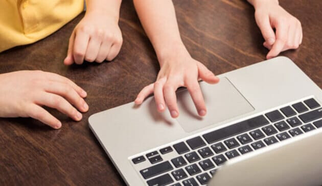 children working on laptop