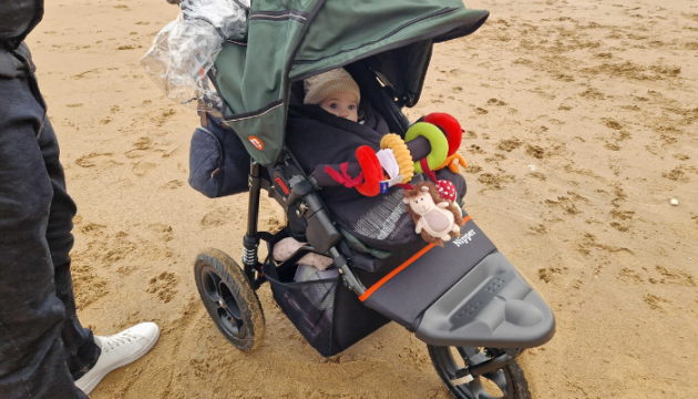 Baby in Out n About Nipper V5 on beach