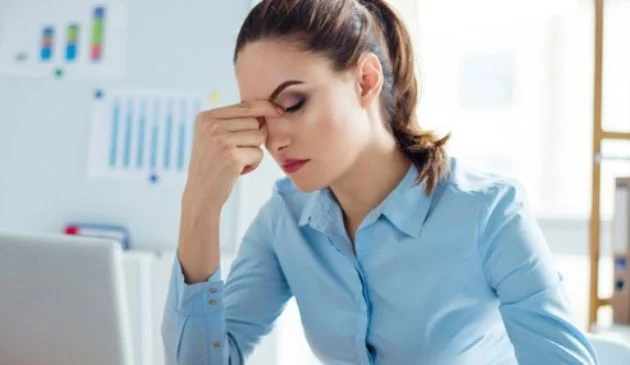 woman pinching bridge of nose