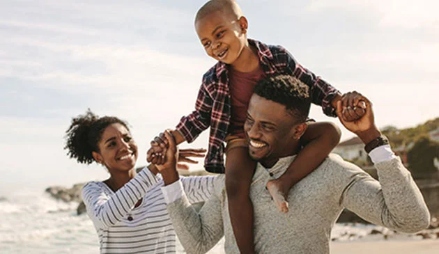 Family smiling on a beach