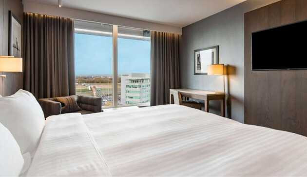 Bed and big window in Raddison Blu Manchester Airport hotel