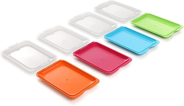 Four flat coloured food trays with removable lids.