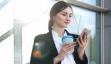 woman holding reusable coffee cup
