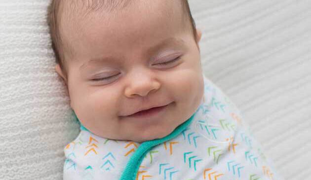 Baby swaddled smiling