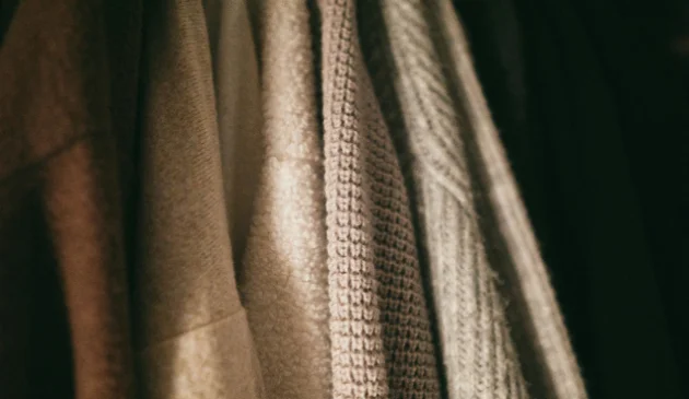 Clothing hanging in a wardrobe