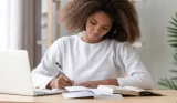 teenager studying with laptop
