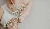 Baby holding flowers