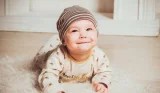 Baby lying on tummy on rug