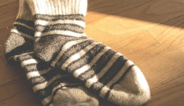 a pair of stripes socks on a wooden surface