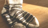 a pair of stripes socks on a wooden surface