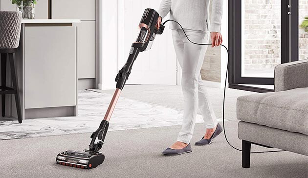 woman using Shark vacuum cleaner