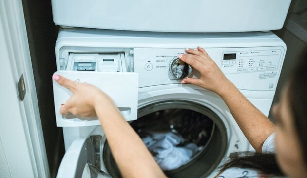 Woman using washing machine