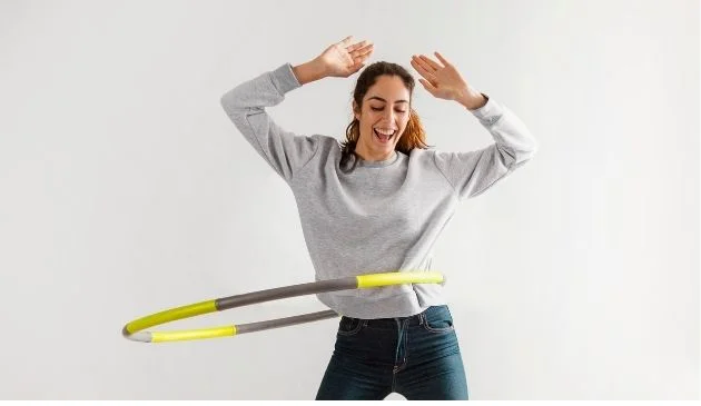 Woman using a weighted hula hoop