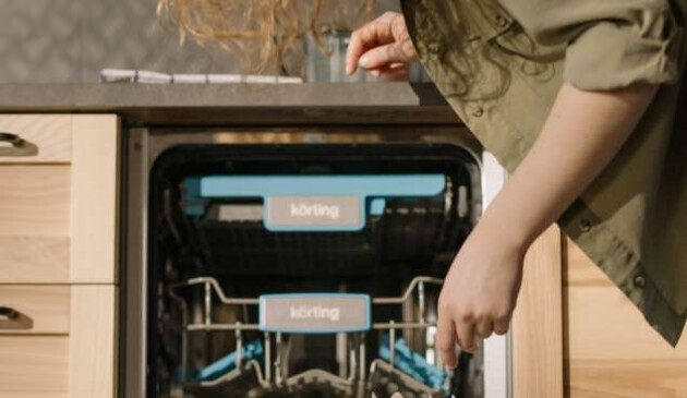 Woman loading dishwasher