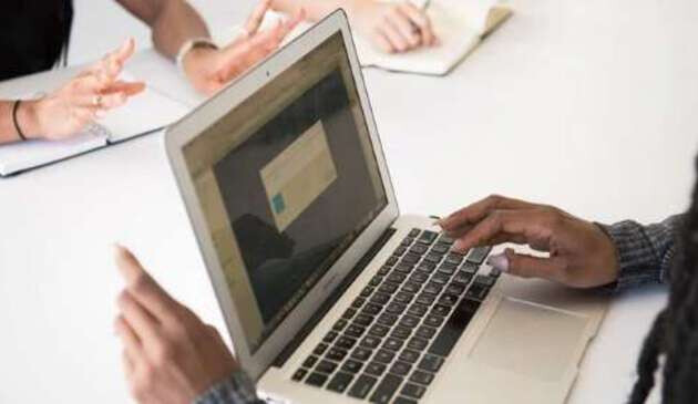 Hands using laptop