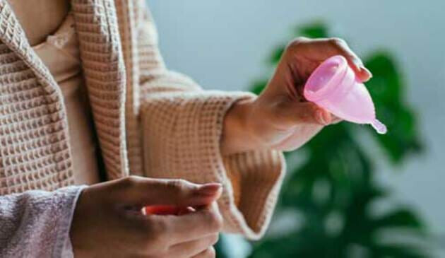 Woman holding menstrual cup