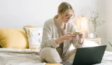Woman on phone and laptop