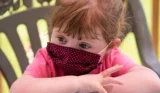 Small child in face mask