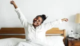 A woman waking up in bed