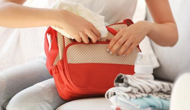 woman packing changing bag