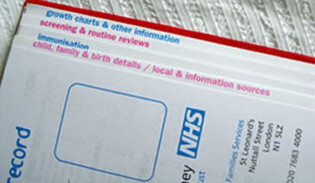 Close up of an NHS baby book